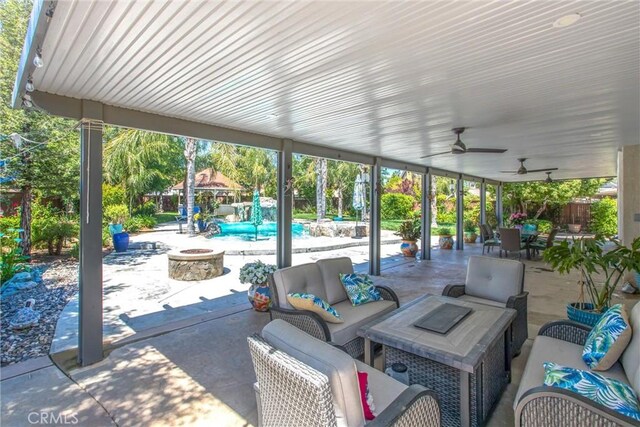 view of patio featuring an outdoor living space with a fire pit and ceiling fan