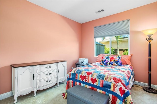bedroom featuring light colored carpet and baseboards