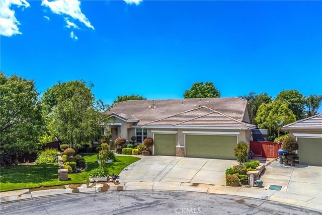 view of front of property with an attached garage, stucco siding, concrete driveway, and a tile roof