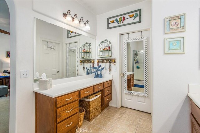 full bath featuring vanity and tile patterned floors
