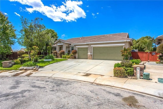 view of front facade with an attached garage, stucco siding, driveway, and a tiled roof