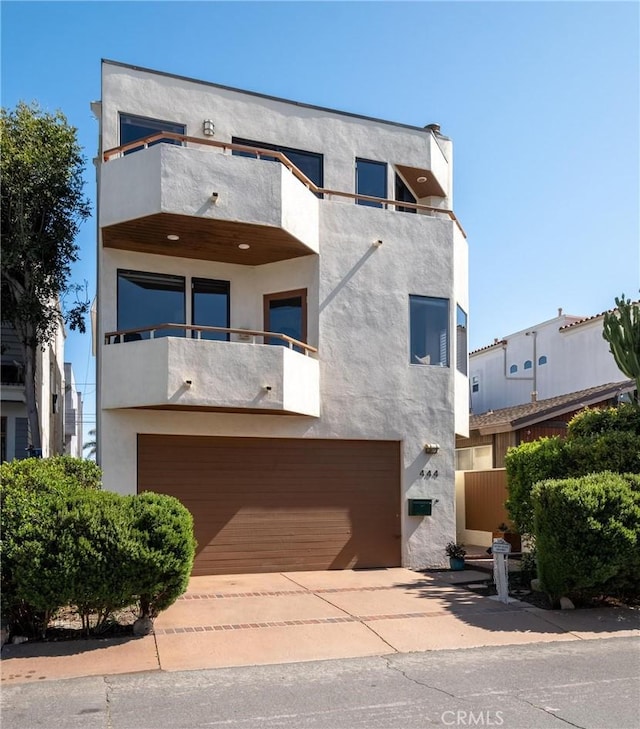 444 30th St, Manhattan Beach, CA 90266 - contemporary home with a balcony, stucco siding, and an attached garage