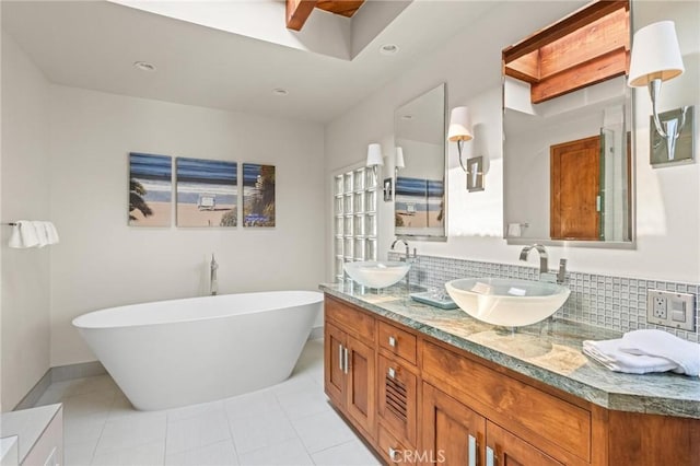 444 30th St, Manhattan Beach, CA 90266 - full bath featuring a freestanding bath, tile patterned floors, double vanity, backsplash, and baseboards
