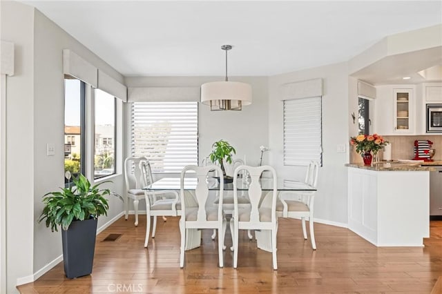 444 30th St, Manhattan Beach, CA 90266 - dining space with wood finished floors, baseboards, and a chandelier