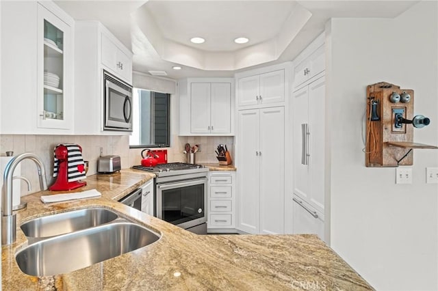 444 30th St, Manhattan Beach, CA 90266 - kitchen featuring appliances with stainless steel finishes, a sink, white cabinetry, light stone countertops, and recessed lighting