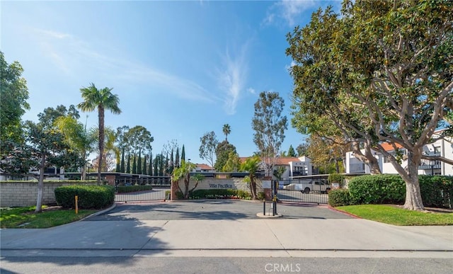 view of street featuring a gate, a residential view, and a gated entry
