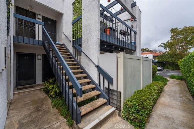 view of home's exterior featuring stairs and stucco siding