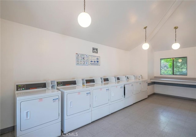 community laundry with washing machine and clothes dryer and baseboards