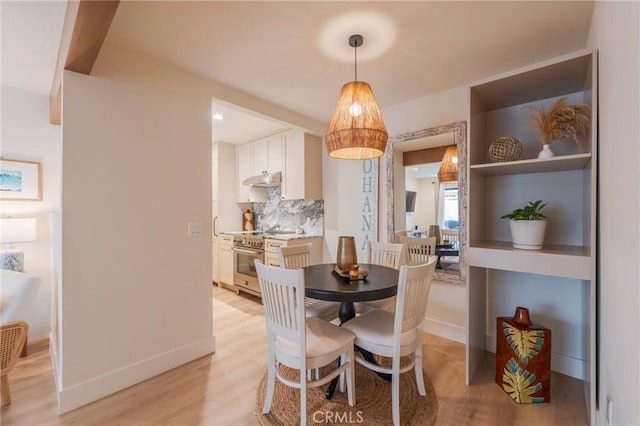 dining room with light wood-style floors and baseboards