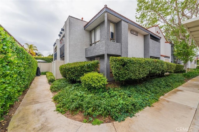 215 Wichita Ave Unit 106, Huntington Beach, CA 92648 - view of side of property featuring stucco siding and a tile roof