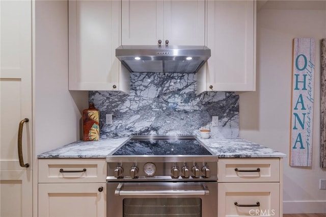 215 Wichita Ave Unit 106, Huntington Beach, CA 92648 - kitchen with high end stove, exhaust hood, backsplash, and light stone countertops