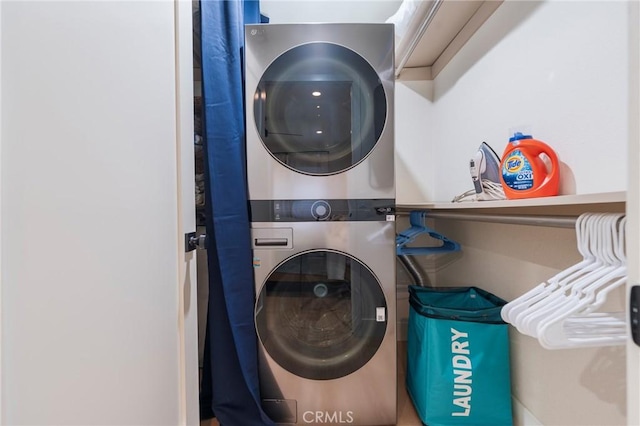laundry room featuring stacked washer and clothes dryer