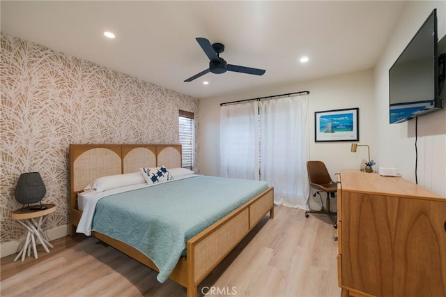 bedroom with wallpapered walls, light wood finished floors, recessed lighting, an accent wall, and ceiling fan
