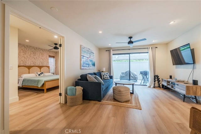 living area featuring a ceiling fan, wood finished floors, and recessed lighting