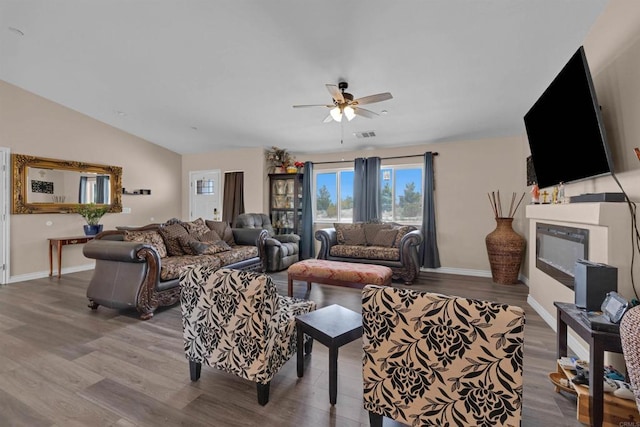 11374 Desert View Rd, Pinon Hills, CA 92372 - living room with ceiling fan, wood finished floors, baseboards, a fireplace, and lofted ceiling