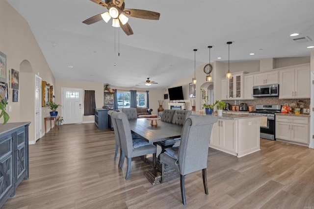 11374 Desert View Rd, Pinon Hills, CA 92372 - dining room with a ceiling fan, arched walkways, light wood-style flooring, recessed lighting, and high vaulted ceiling