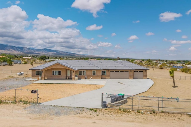 11374 Desert View Rd, Pinon Hills, CA 92372 - ranch-style home featuring concrete driveway, a fenced front yard, a garage, a tiled roof, and a mountain view
