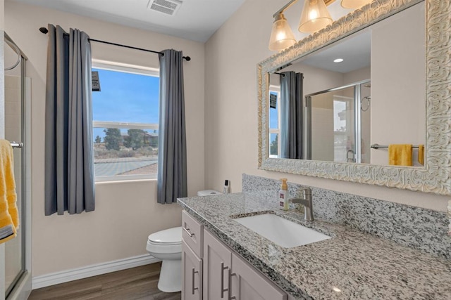 11374 Desert View Rd, Pinon Hills, CA 92372 - bathroom with wood finished floors, toilet, a stall shower, baseboards, and vanity