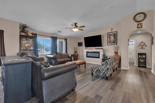 11374 Desert View Rd, Pinon Hills, CA 92372 - living room featuring arched walkways, ceiling fan, wood finished floors, baseboards, and lofted ceiling