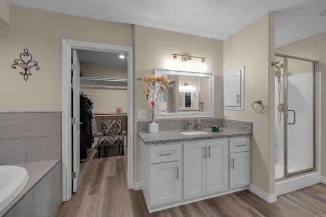 11374 Desert View Rd, Pinon Hills, CA 92372 - full bath featuring wood finished floors, a shower stall, vanity, and a spacious closet