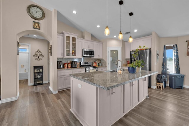 11374 Desert View Rd, Pinon Hills, CA 92372 - kitchen with appliances with stainless steel finishes, a sink, arched walkways, white cabinetry, and recessed lighting