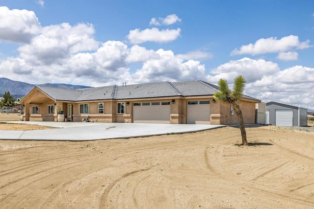 11374 Desert View Rd, Pinon Hills, CA 92372 - view of front facade with a tiled roof, driveway, an attached garage, and stucco siding
