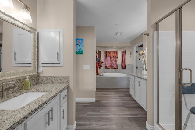 11374 Desert View Rd, Pinon Hills, CA 92372 - bathroom with wood finished floors, vanity, baseboards, a bath, and a stall shower