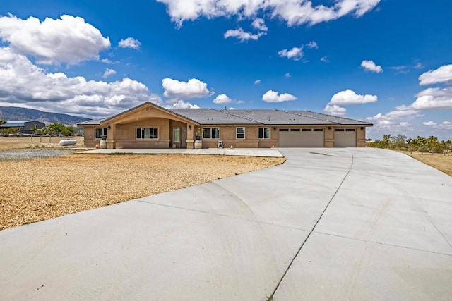 11374 Desert View Rd, Pinon Hills, CA 92372 - single story home featuring a garage, concrete driveway, a tiled roof, stucco siding, and a mountain view