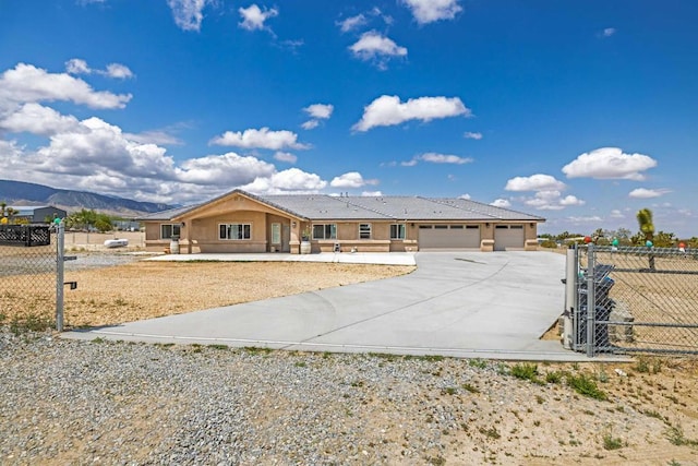 11374 Desert View Rd, Pinon Hills, CA 92372 - single story home with concrete driveway, a gate, an attached garage, stucco siding, and a mountain view