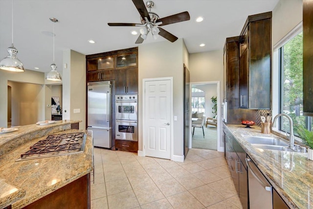 3522 Lancewood Way, Fallbrook, CA 92028 - kitchen with stainless steel appliances, light stone counters, dark brown cabinets, plenty of natural light, and recessed lighting