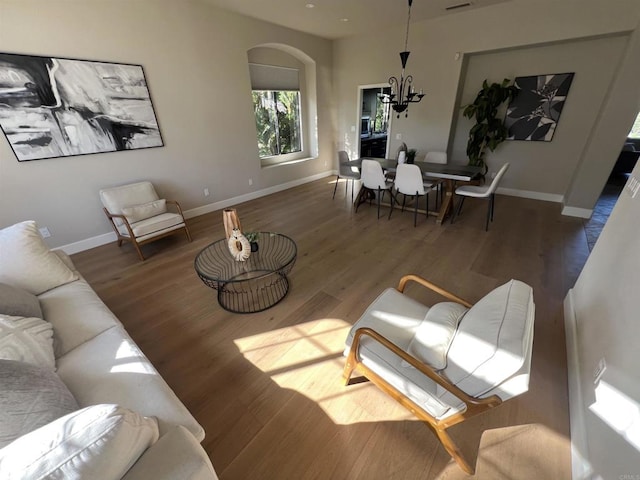 3522 Lancewood Way, Fallbrook, CA 92028 - living room featuring wood finished floors, a chandelier, and arched walkways