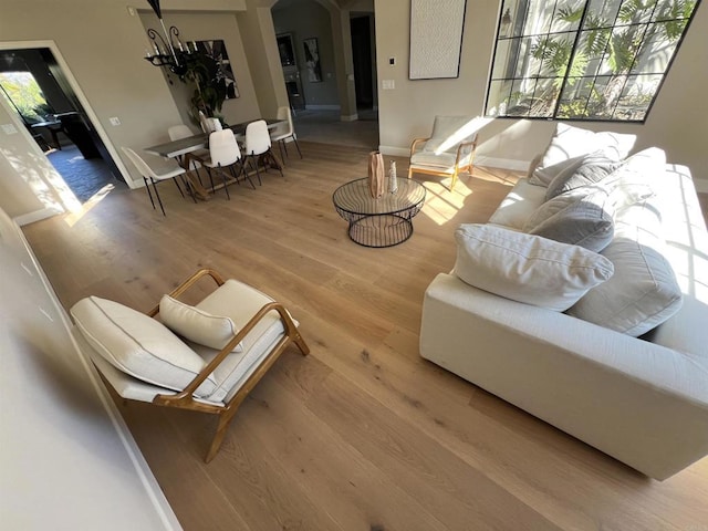 3522 Lancewood Way, Fallbrook, CA 92028 - living room featuring wood finished floors, arched walkways, and a chandelier