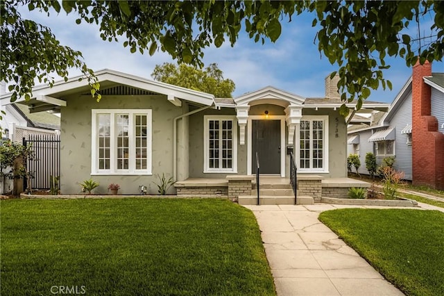 5738 7th Ave, Los Angeles, CA 90043 - view of front of home featuring stucco siding, a front yard, and a chimney