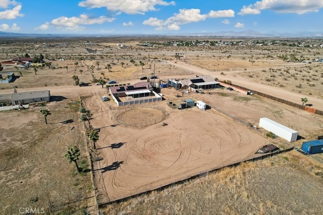 aerial view of property's location with a desert landscape, rural landscape, and a mountainous background