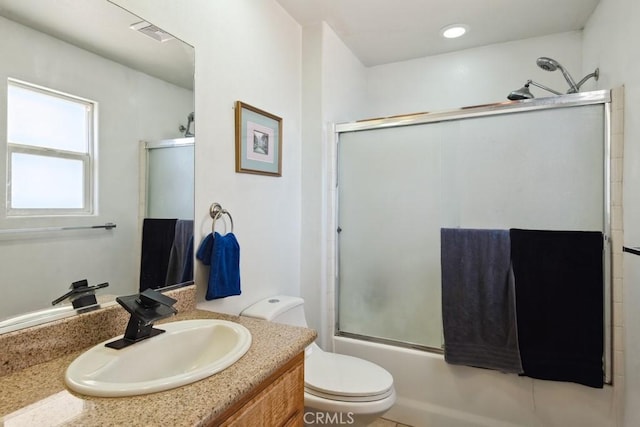 full bathroom with toilet, shower / bath combination with glass door, and vanity