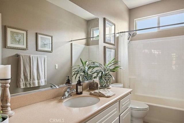 bathroom featuring toilet, vanity, and shower / bath combination with curtain