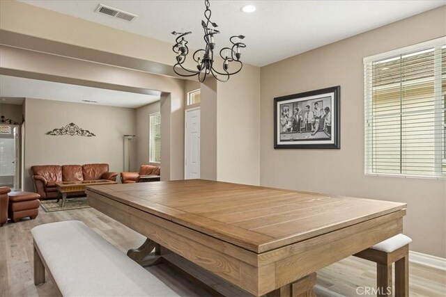 dining room featuring light wood finished floors, a chandelier, recessed lighting, and baseboards