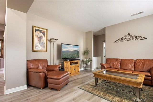 living room with light wood-style floors and baseboards