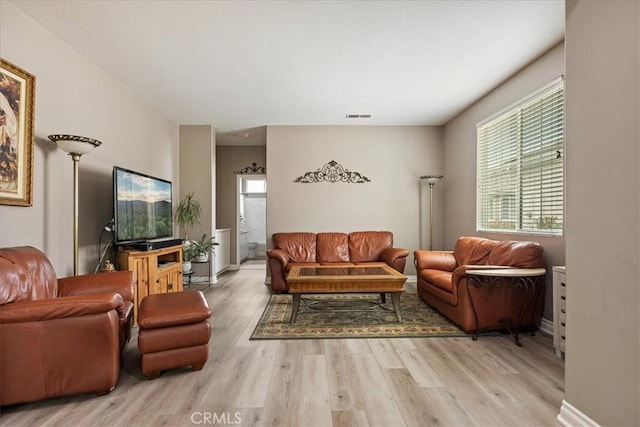 living area with wood finished floors and baseboards