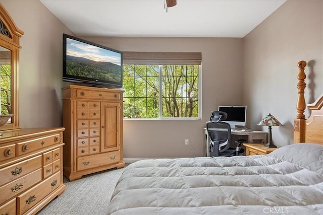 bedroom featuring ceiling fan, baseboards, and light colored carpet
