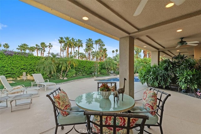 view of patio with a ceiling fan and outdoor dining area