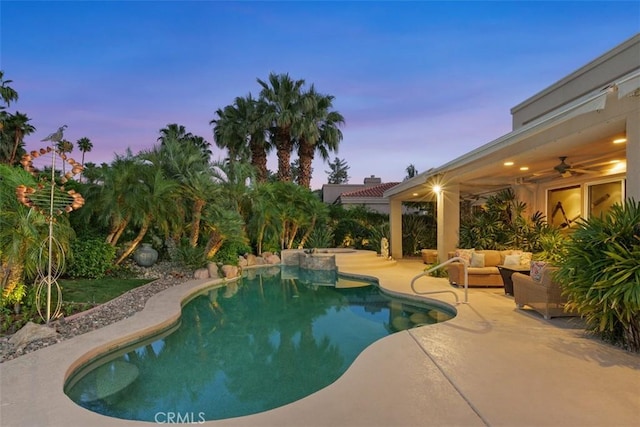 outdoor pool featuring a patio, a ceiling fan, and an outdoor hangout area