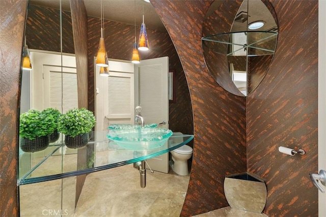 bathroom with toilet and tile patterned floors