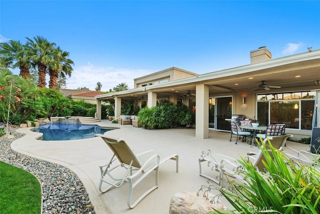 swimming pool with ceiling fan, a patio area, and an outdoor living space