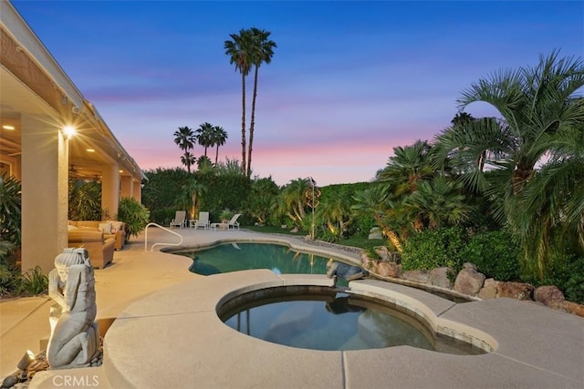 view of pool with a patio and a pool with connected hot tub