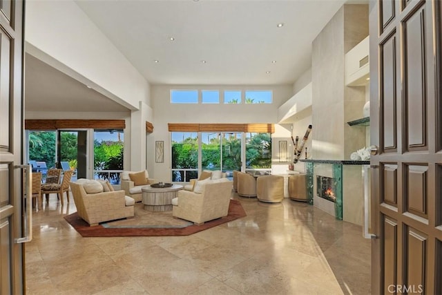 living area with a towering ceiling and recessed lighting
