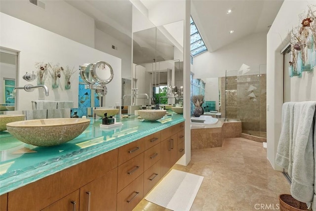 full bathroom featuring a tile shower, a garden tub, high vaulted ceiling, double vanity, and tile patterned flooring