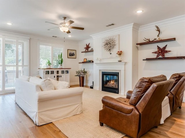 8670 Erika Ct, Atascadero, CA 93422 - living room with a ceiling fan, ornamental molding, light wood-style floors, a glass covered fireplace, and recessed lighting