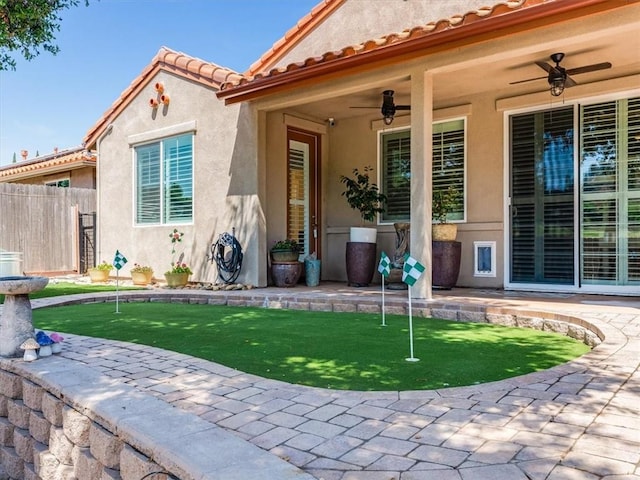 8670 Erika Ct, Atascadero, CA 93422 - view of exterior entry with ceiling fan, a patio, fence, stucco siding, and a tile roof