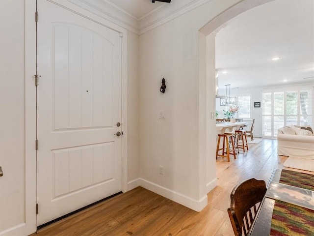8670 Erika Ct, Atascadero, CA 93422 - foyer entrance featuring light wood-style flooring, arched walkways, baseboards, crown molding, and recessed lighting